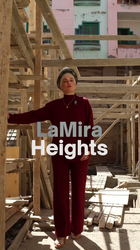 Presenter at the construction site, with La Mira Heights named on screen.