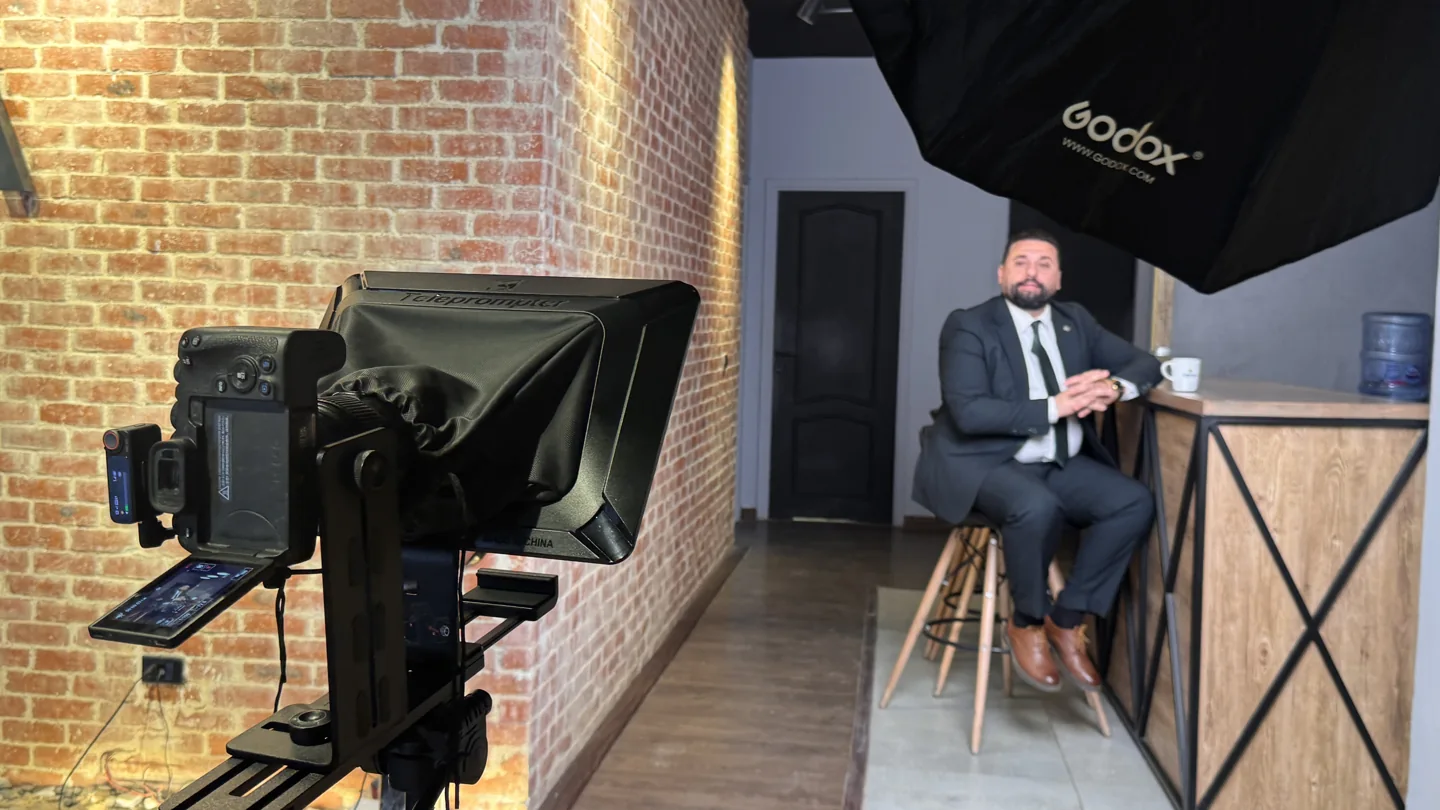 Camera, teleprompter, and lighting arranged for a commercial interview