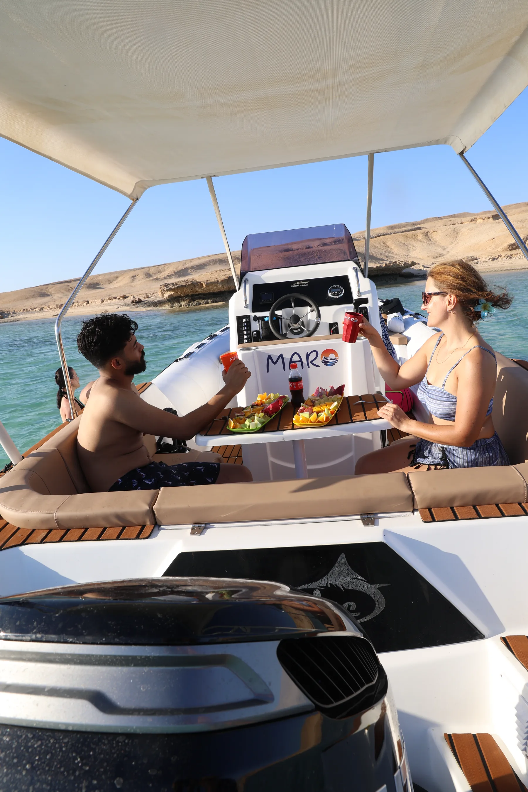 Guests sharing refreshments aboard a MARO Red Sea speedboat